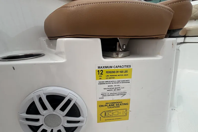 Slide: The Image of NauticStar 242L Offshore 2025 boat seat with capacity label and speaker detail. - 9