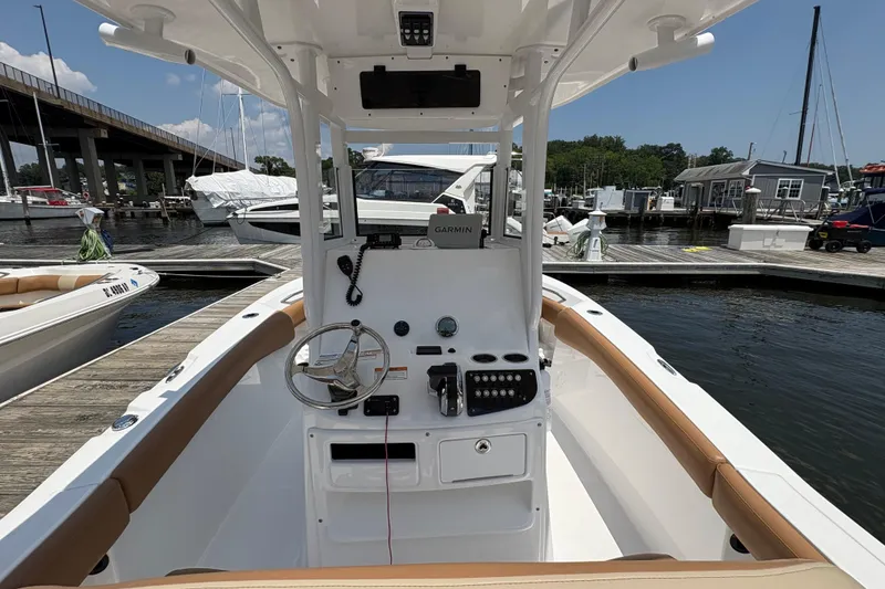 Slide: The Image of 2025 NauticStar 242L Offshore boat interior at marina dock. - 5