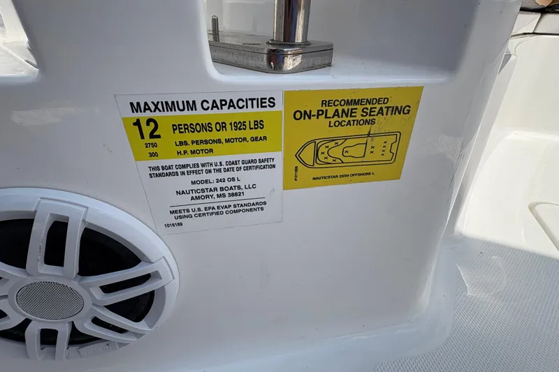 Slide: The Image of 2025 NauticStar 242L Offshore capacity label, seating guide, and speaker detail. - 8