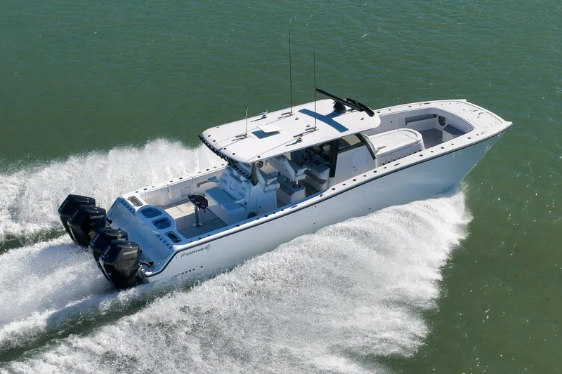 Slide: The Image of 2023 Freeman 43 boat cruising on water with powerful outboard engines. - 15