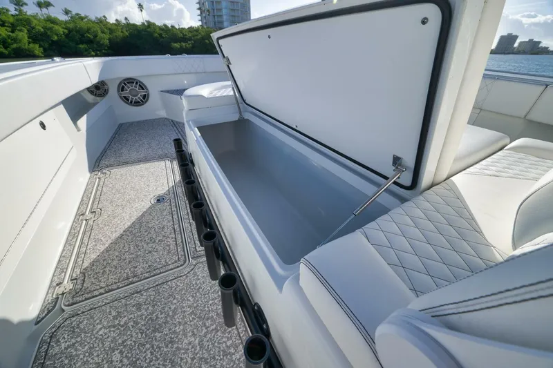 Slide: The Image of 2023 Freeman 43 boat interior with open storage compartment and rod holders. - 23