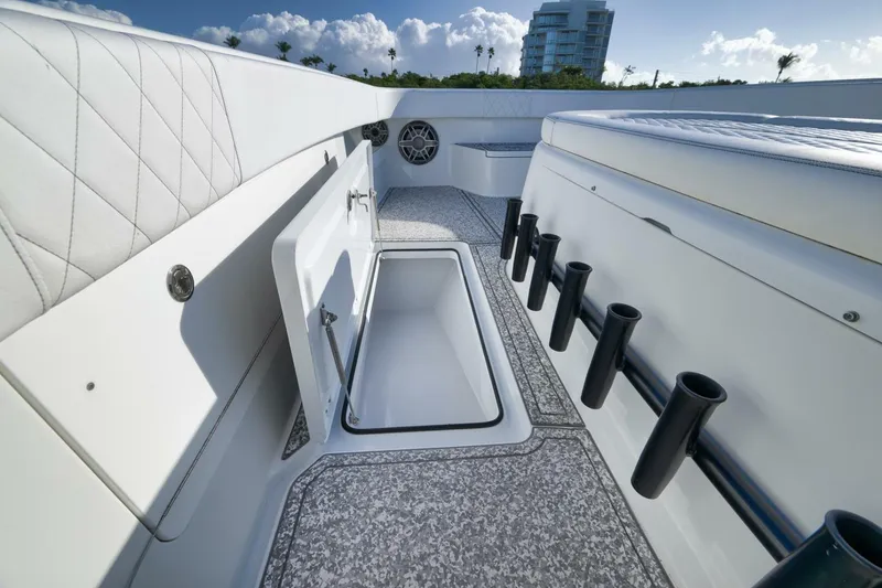 Slide: The Image of Interior of 2023 Freeman 43 boat with open storage compartment and rod holders. - 25
