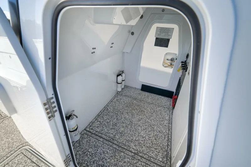 Slide: The Image of Interior view of 2023 Freeman 43 boat compartment with fire extinguishers. - 26