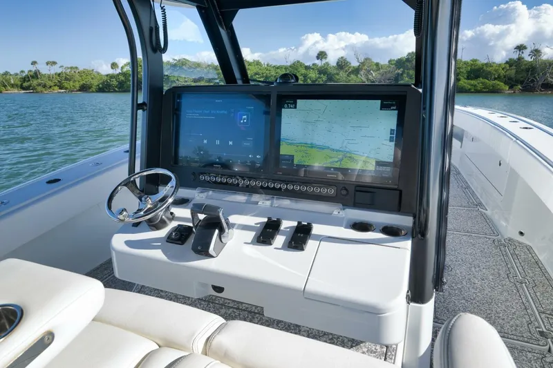 Slide: The Image of Helm of 2023 Freeman 43 boat with navigation screens and steering wheel. - 31