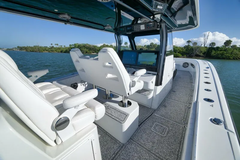 Slide: The Image of 2023 Freeman 43 boat interior with modern helm, white seating, and scenic water view. - 33