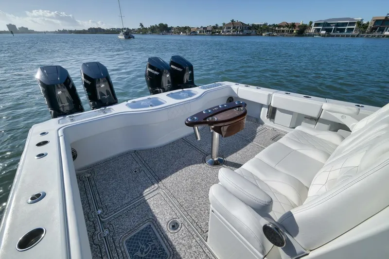 Slide: The Image of 2023 Freeman 43 boat interior with luxurious seating and multiple Mercury outboard engines. - 34