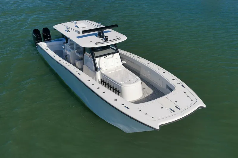 Slide: The Image of 2023 Freeman 43 boat on calm water, featuring sleek design and dual engines. - 4