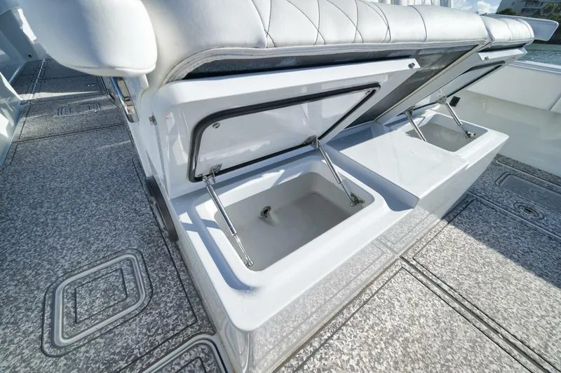 Slide: The Image of 2023 Freeman 43 boat with open storage compartments on deck. - 43