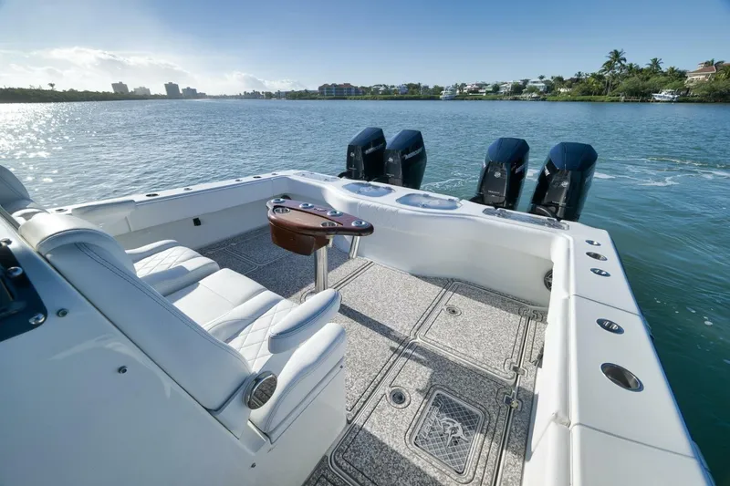 Slide: The Image of Luxury Freeman 43 boat deck with seating, table, and four powerful engines, 2023 model. - 44