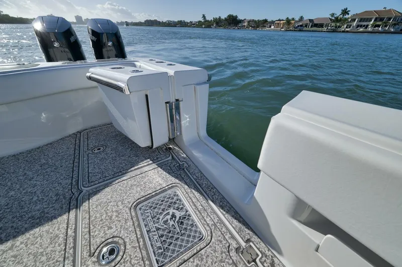 Slide: The Image of Freeman 43 boat deck with dual Mercury engines, 2023 model, on calm water. - 45