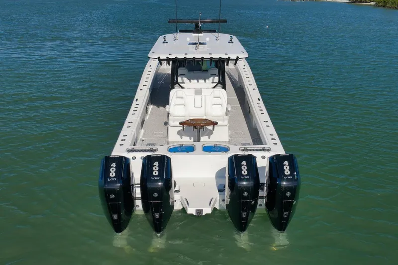 Slide: The Image of 2023 Freeman 43 boat with four powerful outboard engines on calm water. - 9