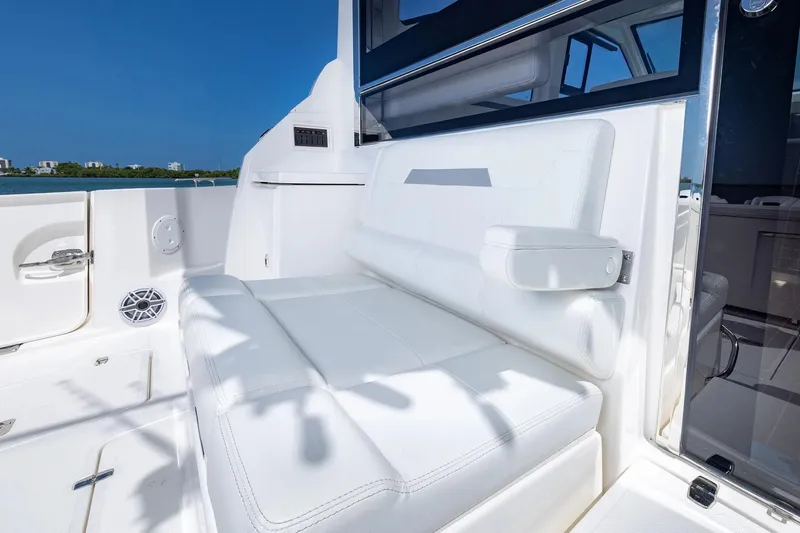 Slide: The Image of Manufacturer Provided Image: 2025 Pursuit OS 445 Offshore boat interior with white seating and armrest. - 19