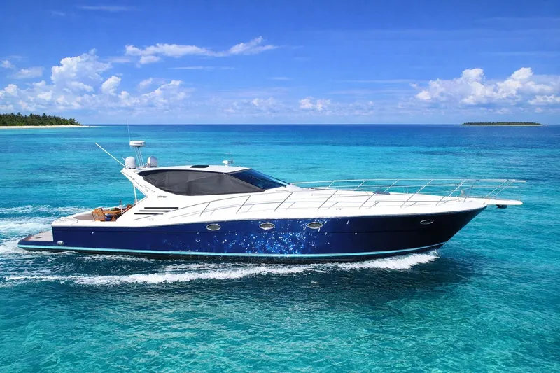 The Image of 1999 Uniesse 57 Open yacht cruising on clear turquoise waters. - 0
