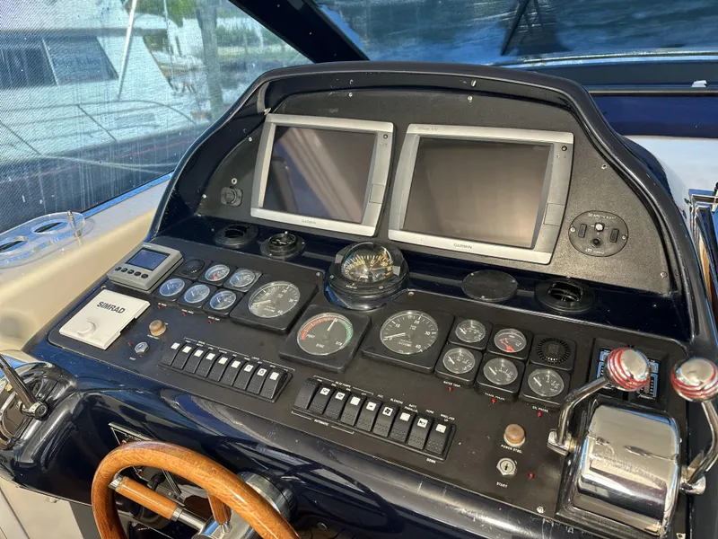 Slide: The Image of Control panel of a 1999 Uniesse 57 Open yacht with dual screens and gauges. - 28
