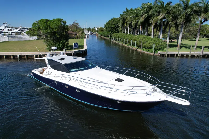 Slide: The Image of Luxury 1999 Uniesse 57 Open yacht cruising on a scenic waterway. - 3