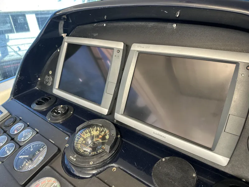 Slide: The Image of Control panel of 1999 Uniesse 57 Open yacht with navigation screens and compass. - 35