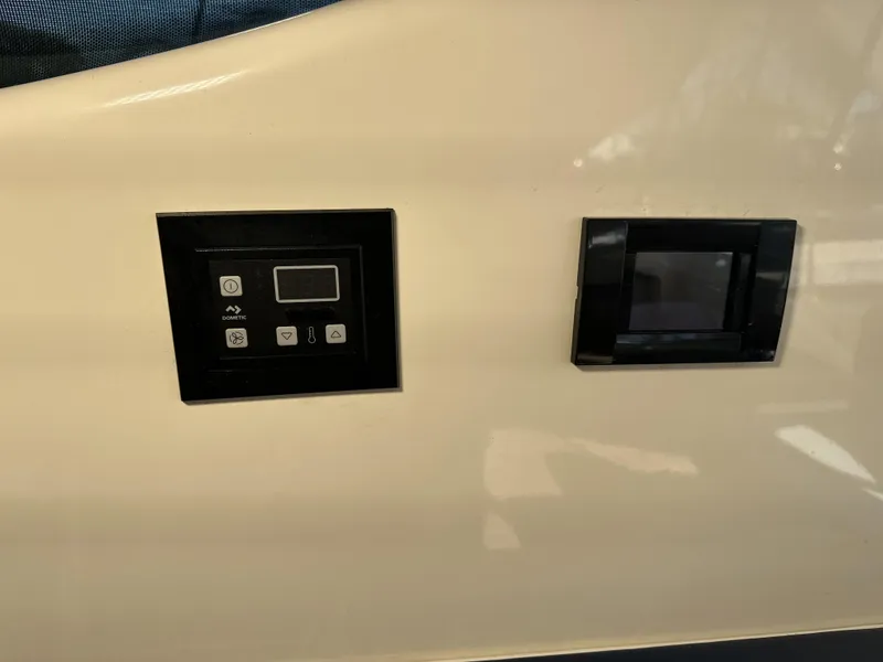 Slide: The Image of Control panels on a 1999 Uniesse 57 Open yacht interior. - 43
