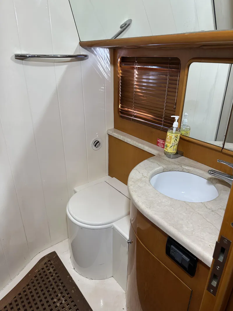 Slide: The Image of Bathroom interior of 1999 Uniesse 57 Open yacht, featuring sink and toilet. - 46