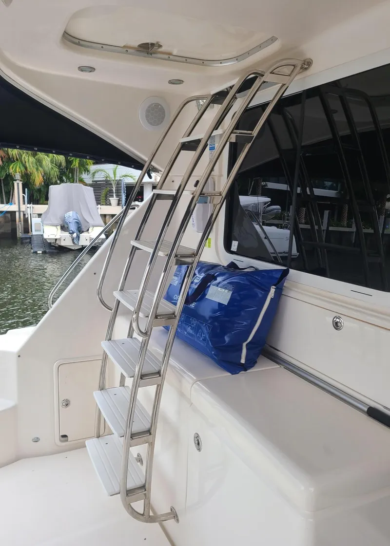 Slide: The Image of 2009 Riviera 47 Enclosed Flybridge Series II ladder and seating area - 46