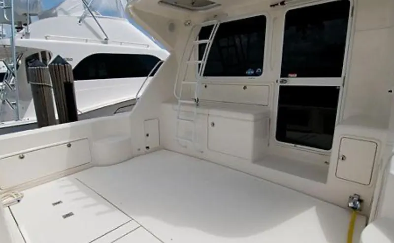 Slide: The Image of 2009 Riviera 47 Enclosed Flybridge Series II yacht deck with ladder and storage compartments. - 48