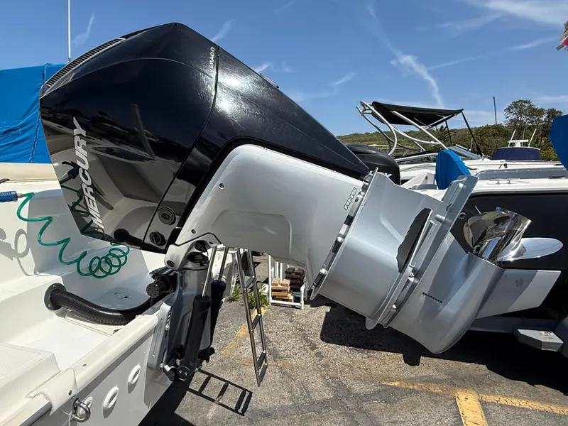 Slide: The Image of 2019 Boston Whaler 230 Outrage with Mercury outboard engine, parked outdoors. - 10