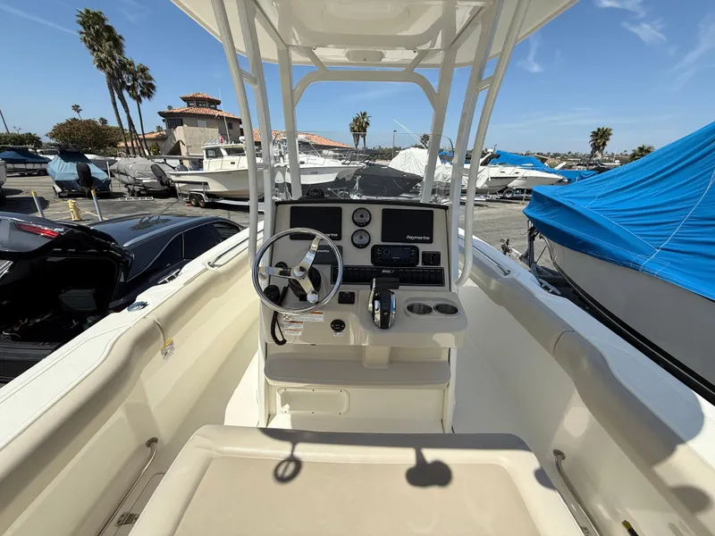 Slide: The Image of 2019 Boston Whaler 230 Outrage boat interior with steering console, parked in marina. - 15