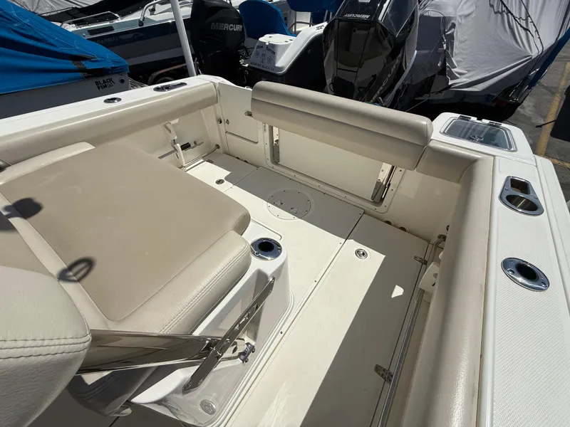 Slide: The Image of 2019 Boston Whaler 230 Outrage boat interior with seating and cup holders. - 16