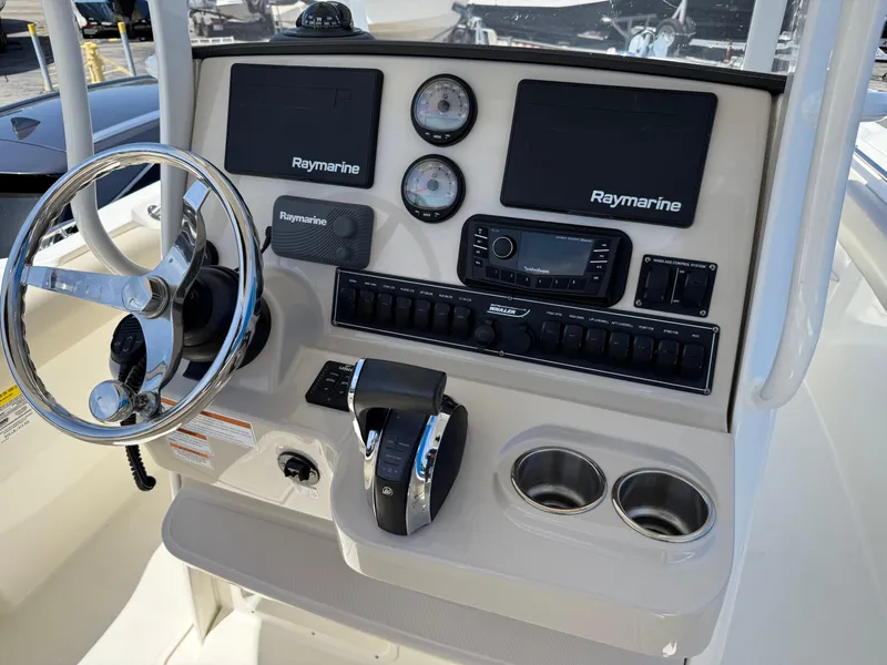 Slide: The Image of Control panel of 2019 Boston Whaler 230 Outrage with Raymarine electronics and steering wheel. - 18