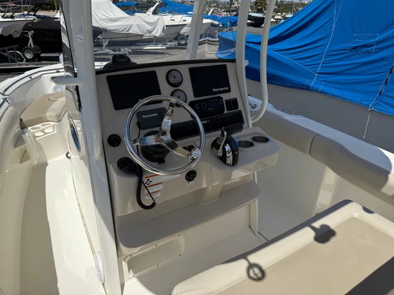 Slide: The Image of 2019 Boston Whaler 230 Outrage boat console with steering wheel and controls. - 19
