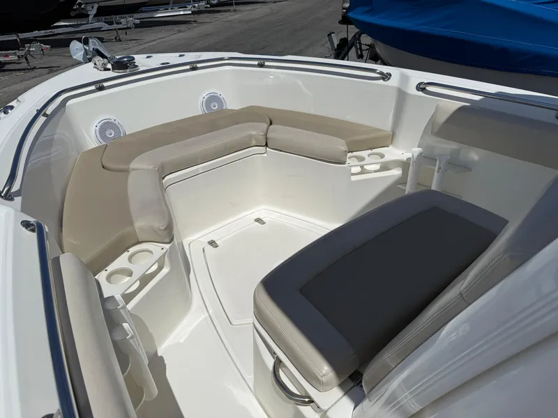 Slide: The Image of 2019 Boston Whaler 230 Outrage boat interior with cushioned seating and cup holders. - 23