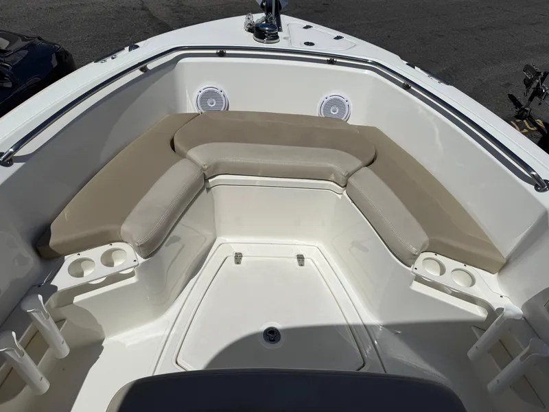 Slide: The Image of 2019 Boston Whaler 230 Outrage boat interior with cushioned seating and cup holders. - 24