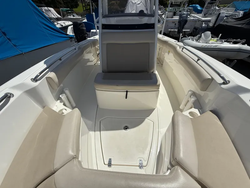 Slide: The Image of 2019 Boston Whaler 230 Outrage boat interior with seating and storage compartments. - 25