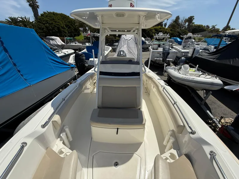 Slide: The Image of 2019 Boston Whaler 230 Outrage boat docked, showcasing spacious interior and seating. - 26