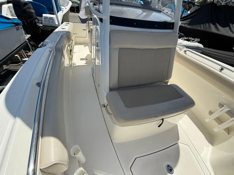 Slide: The Image of 2019 Boston Whaler 230 Outrage boat interior with seating and storage features. - 27