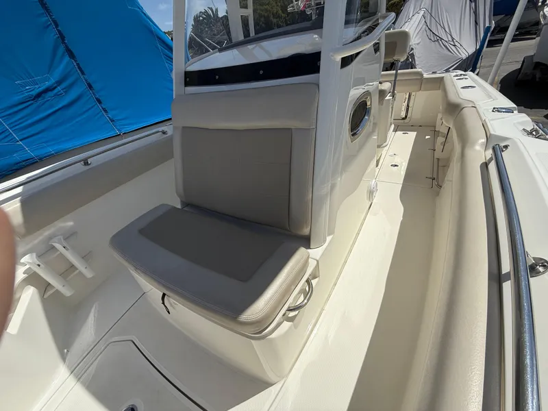 Slide: The Image of 2019 Boston Whaler 230 Outrage boat interior with seating and console. - 28