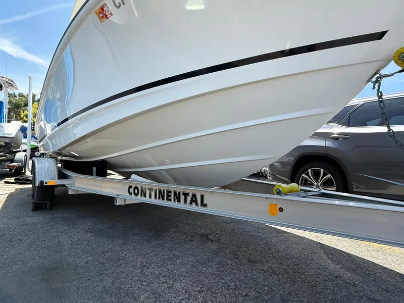 Slide: The Image of 2019 Boston Whaler 230 Outrage on Continental trailer, parked outdoors. - 31
