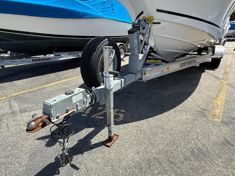 Slide: The Image of 2019 Boston Whaler 230 Outrage on a trailer in a parking lot. - 33