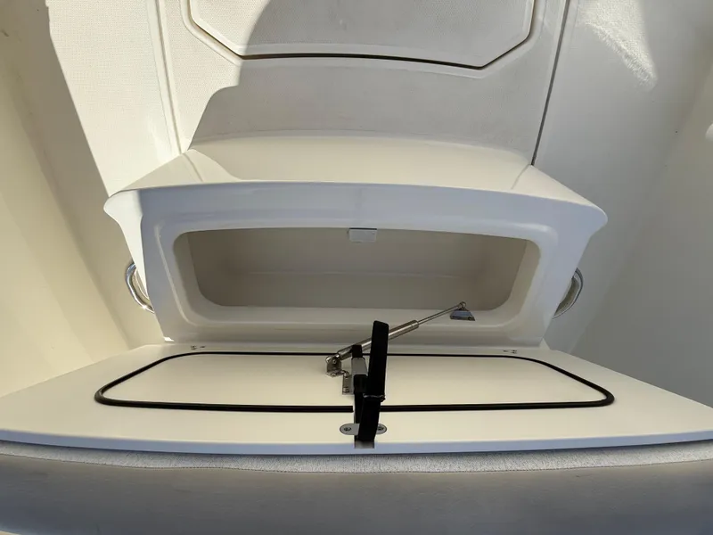 Slide: The Image of 2019 Boston Whaler 230 Outrage storage compartment, open and empty, showcasing interior space. - 44