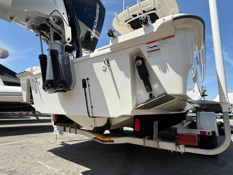 Slide: The Image of 2019 Boston Whaler 230 Outrage on trailer, rear view with outboard motor. - 5