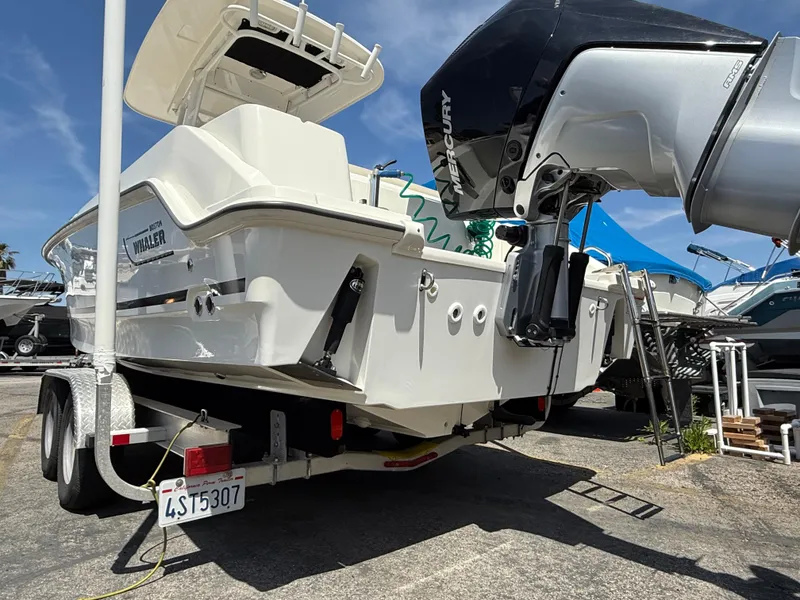 Slide: The Image of 2019 Boston Whaler 230 Outrage on trailer, featuring powerful Mercury outboard engine. - 6