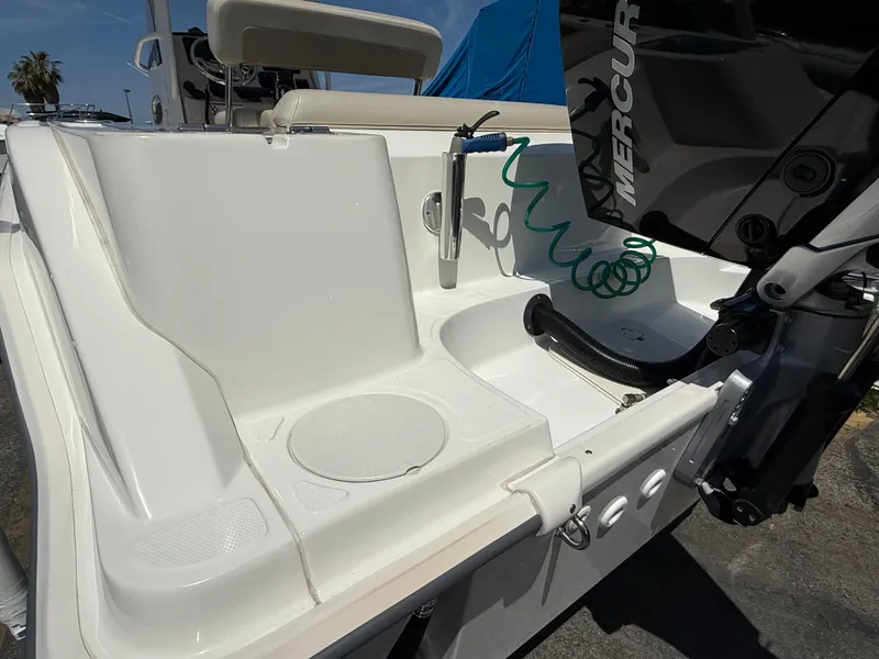 Slide: The Image of 2019 Boston Whaler 230 Outrage boat stern with Mercury engine and washdown hose. - 7