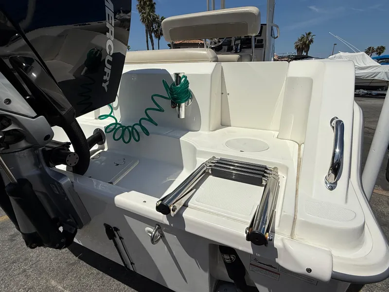 Slide: The Image of 2019 Boston Whaler 230 Outrage boat stern with ladder and Mercury engine. - 8
