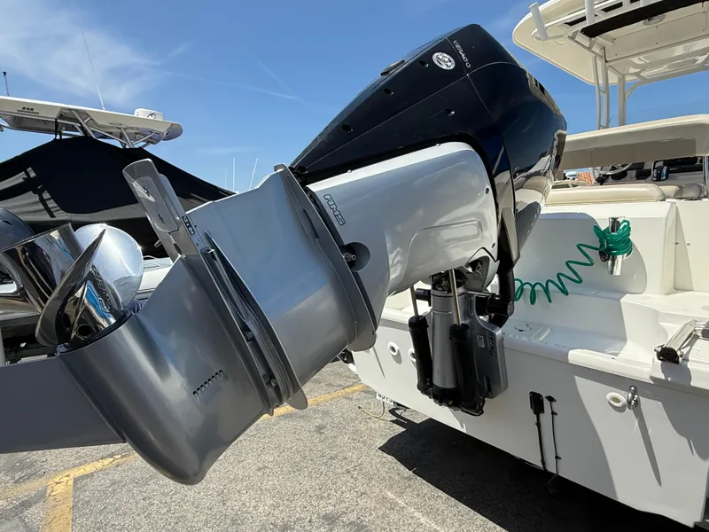 Slide: The Image of 2019 Boston Whaler 230 Outrage boat engine, close-up view in marina setting. - 9