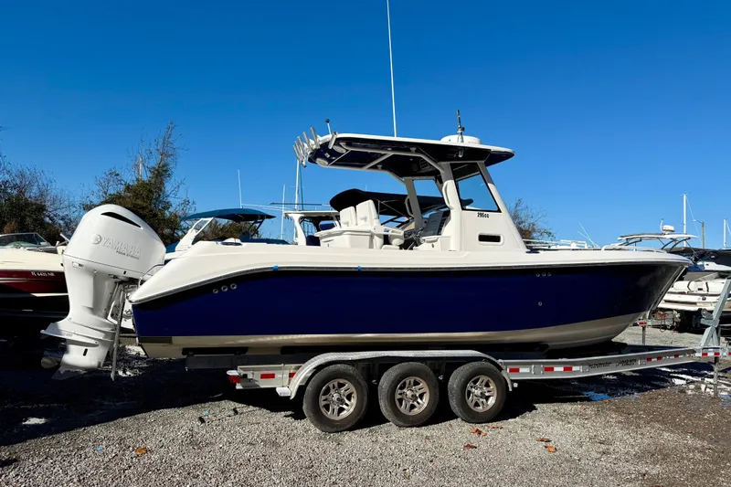 Slide: The Image of 2014 Everglades 295 Center Console boat on trailer, featuring Yamaha outboard motor. - 3