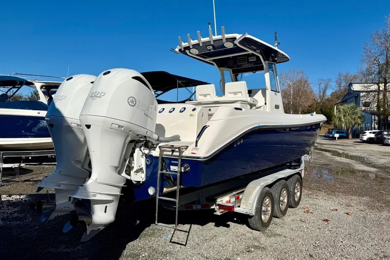 Slide: The Image of 2014 Everglades 295 Center Console boat with twin Yamaha engines on a trailer. - 4