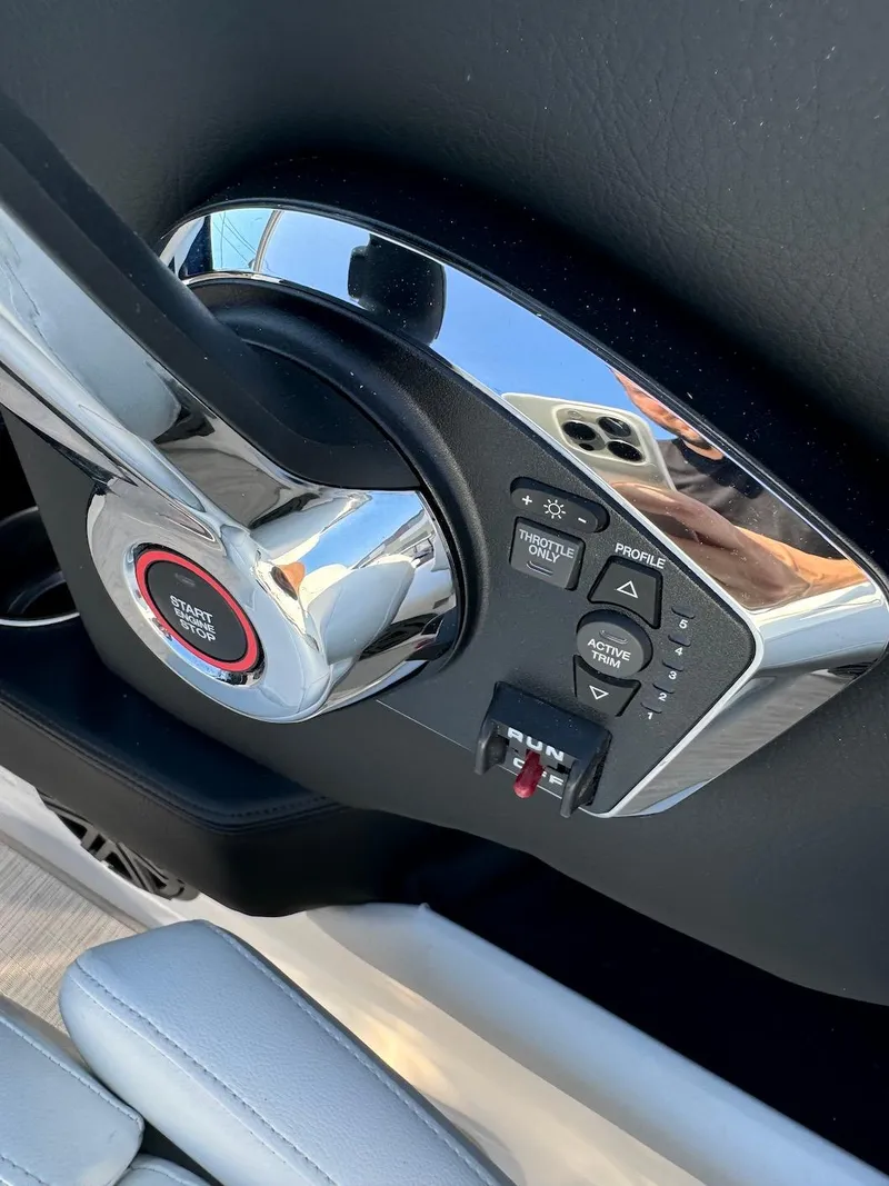 Slide: The Image of 2025 Four Winns H6 OB boat control panel with start button and navigation controls. - 12