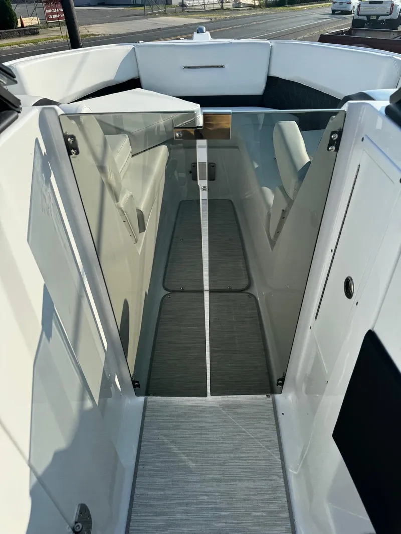 Slide: The Image of 2025 Four Winns H6 OB boat interior with sleek design and modern seating. - 21