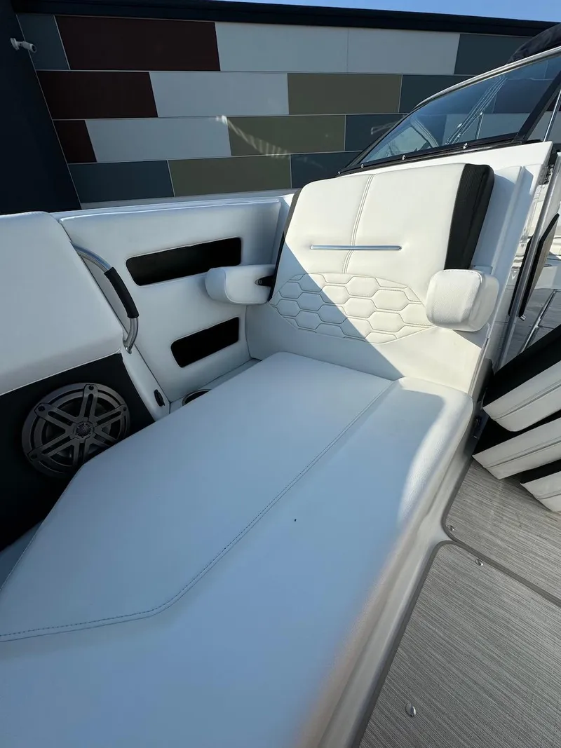 Slide: The Image of 2025 Four Winns H6 OB boat interior with white cushioned seating. - 23