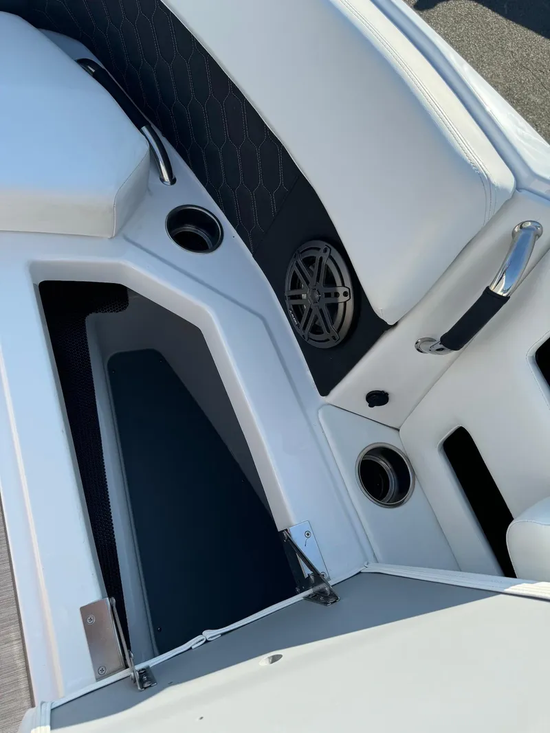 Slide: The Image of 2025 Four Winns H6 OB boat interior with cup holders and seating. - 25