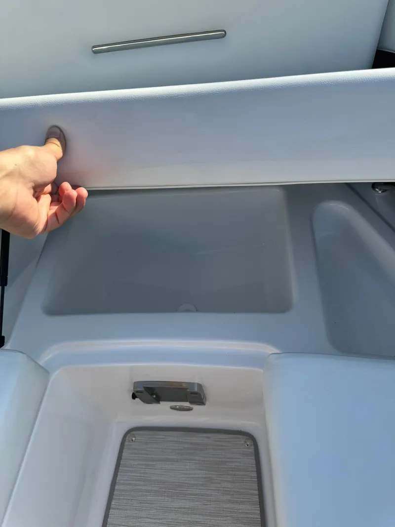 Slide: The Image of 2025 Four Winns H6 OB boat storage compartment being opened. - 26
